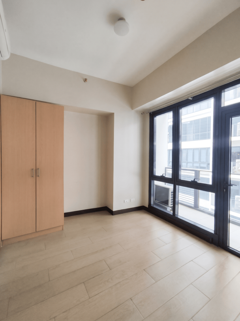 Room with full-height windows to the balcony, The Florence McKinley Hill unit for sale