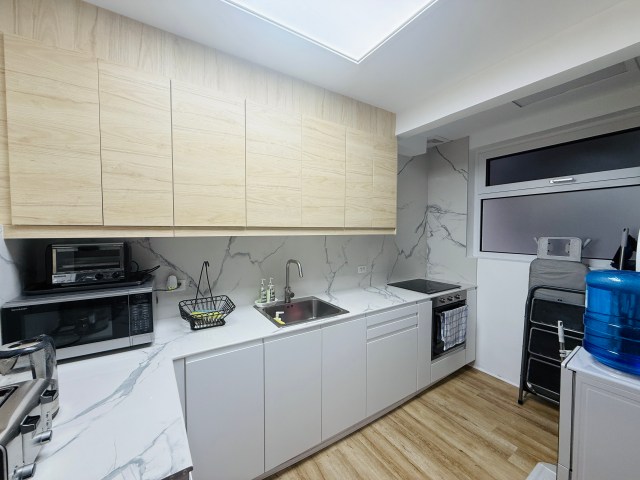 Newly remodeled modern kitchen with built-in appliances at Goldland Tower, Greenhills